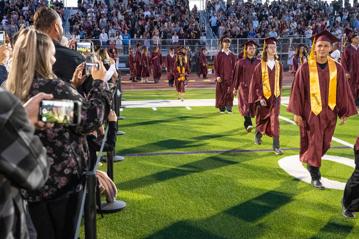 Two hundred seventy-one graduating students filed onto the football field at the start of the c ...