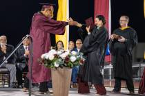 Graduates share a special hug, handshake or dance with Pahrump Valley High School’s Principal ...