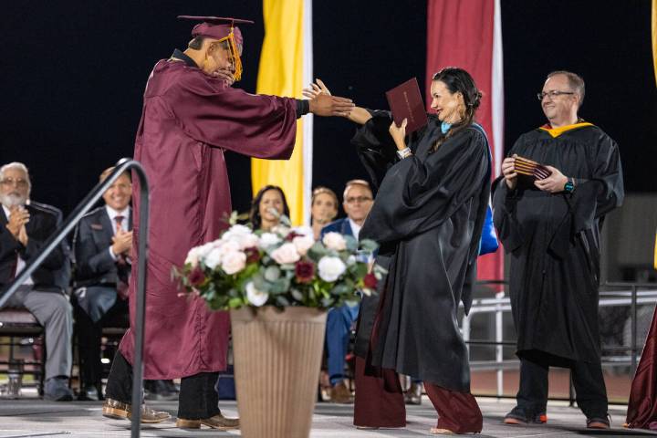 Graduates share a special hug, handshake or dance with Pahrump Valley High School’s Principal ...