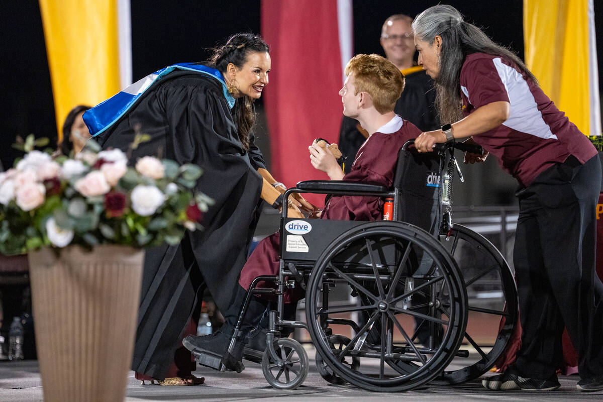 A graduate receives their diploma from Pahrump Valley High School Principal Desiree Veloz. (Joh ...