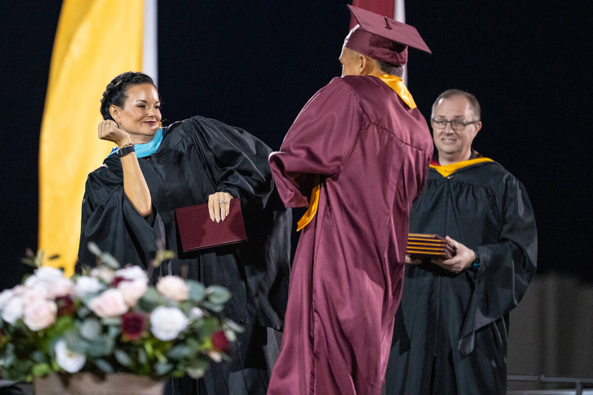 Graduates share a special hug, handshake or dance with Pahrump Valley High School Principal Des ...