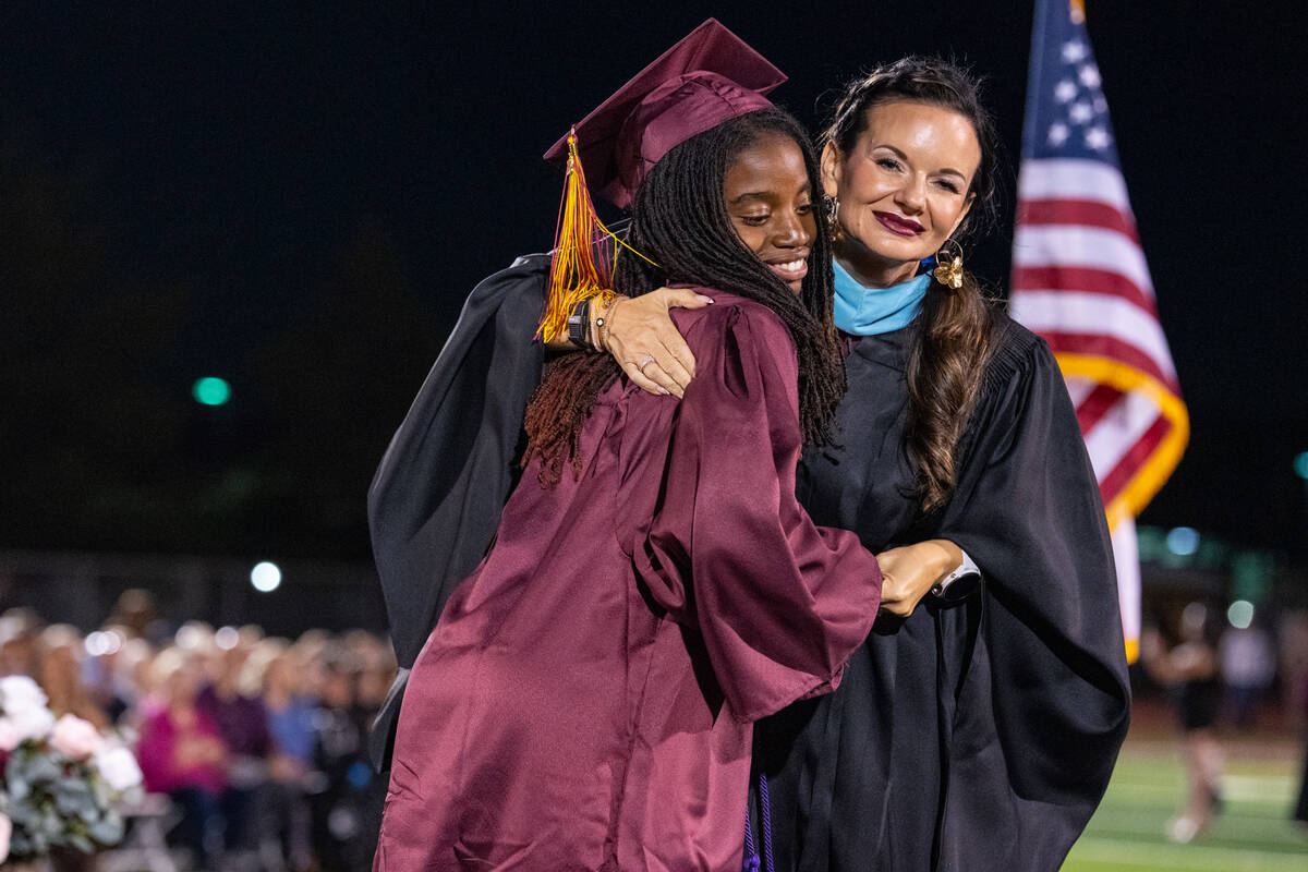 Graduates share a special hug, handshake or dance with Pahrump Valley High School Principal Des ...