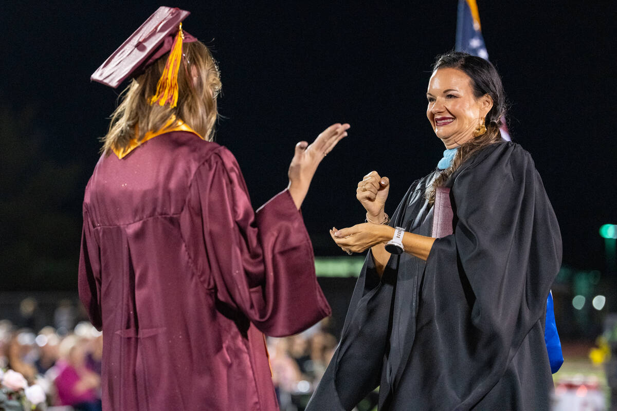 Graduates share a special hug, handshake or dance with Pahrump Valley High School Principal Des ...