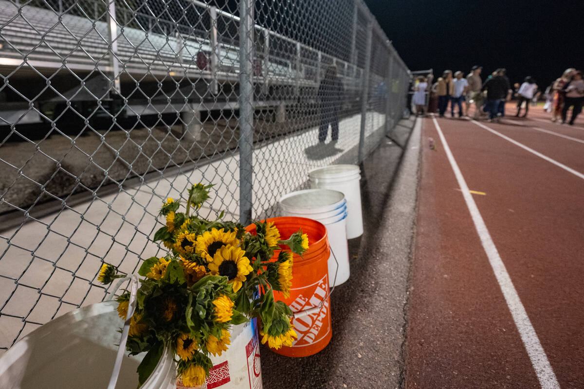 After the ceremony, family and friends went onto the football field to join their graduate. Lef ...