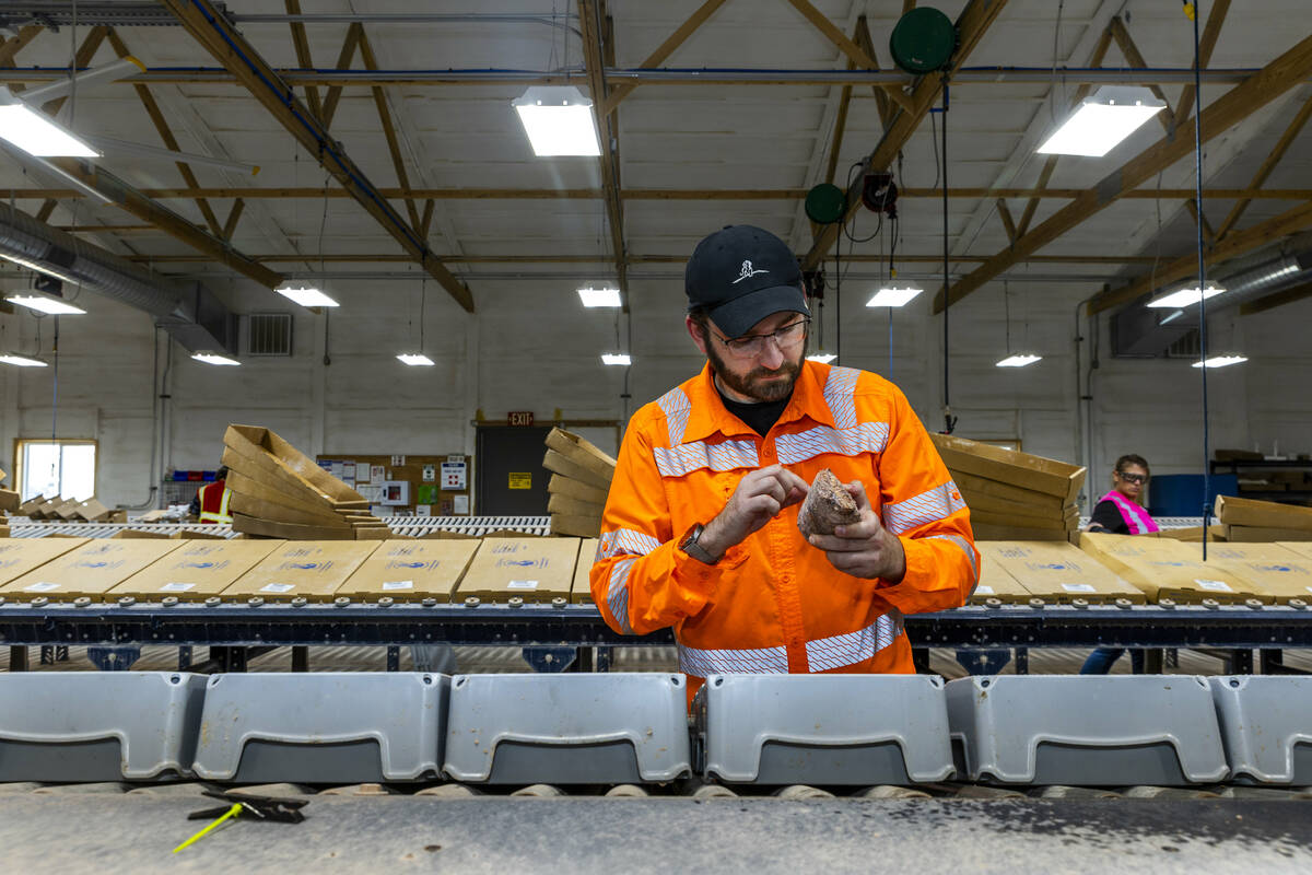 AngloGold Ashanti project geologist Michael Duric examines a core sample from a future gold min ...