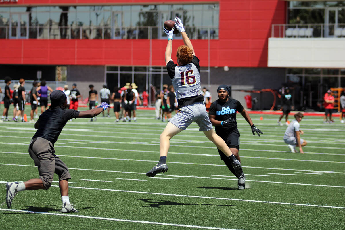 Pahrump Valley High School junior Paul Walker reels in a pass from Hunter Wydick during the Dan ...