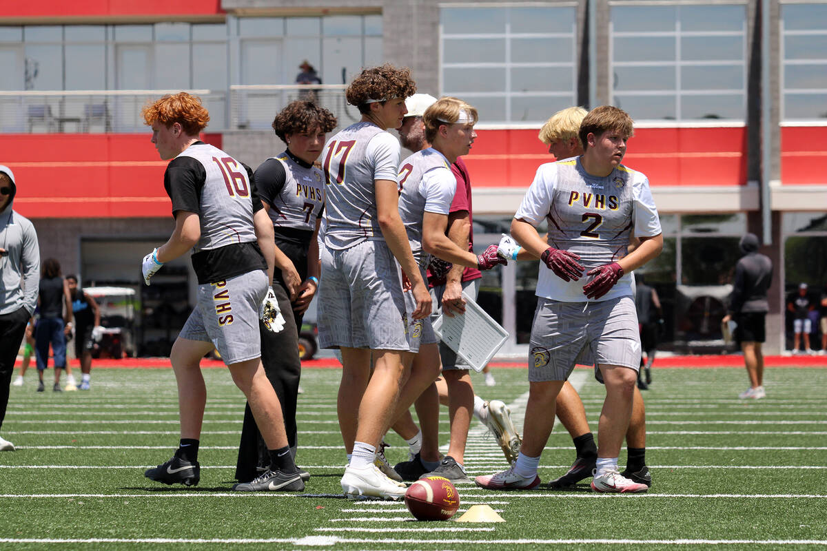 The Trojans break out of a quick huddle before running another down during a 7-on-7 at the Dan ...