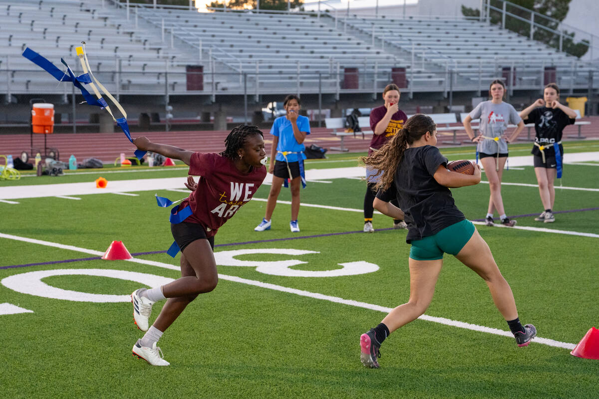 Pahrump Valley High School girls flag football's Ma'liyah Collins (left) pulls the flag of Juli ...