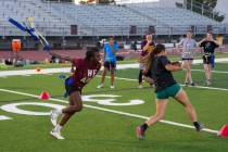 Pahrump Valley High School girls flag football's Ma'liyah Collins (left) pulls the flag of Juli ...