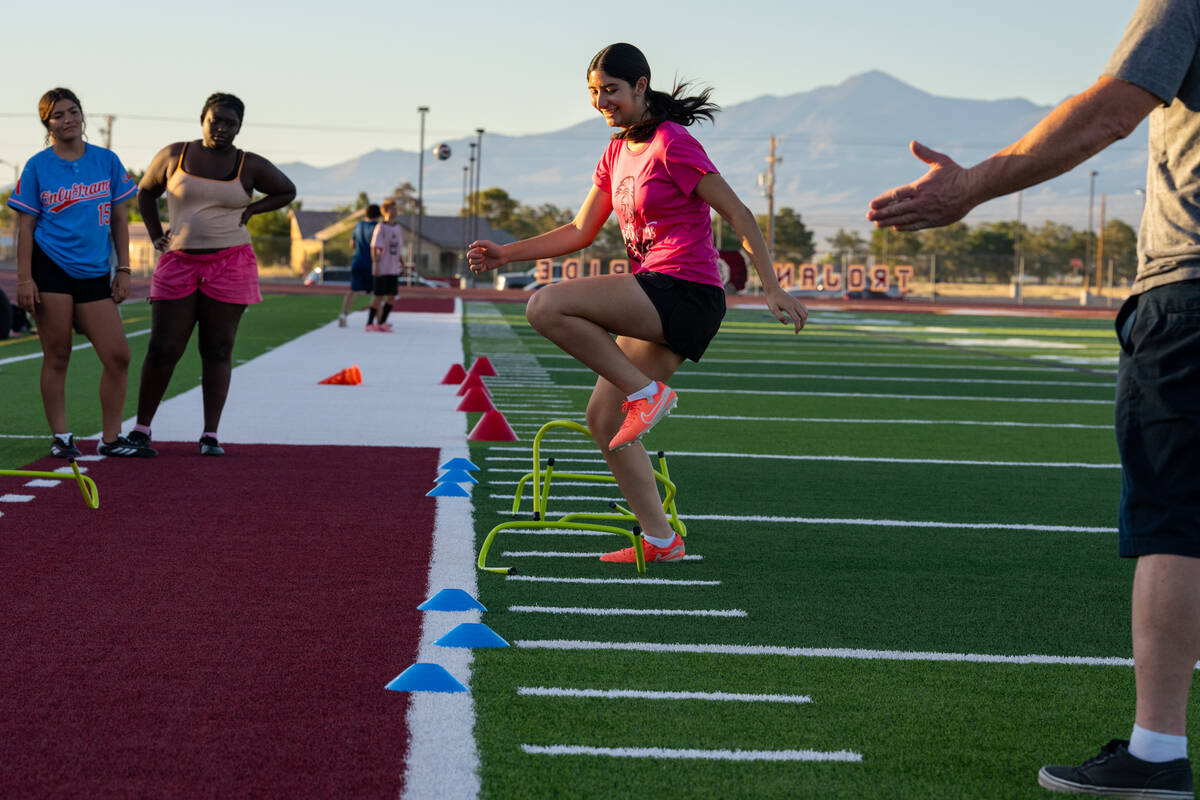 Members of the Pahrump Valley High School girls flag football program run through drills on Wed ...
