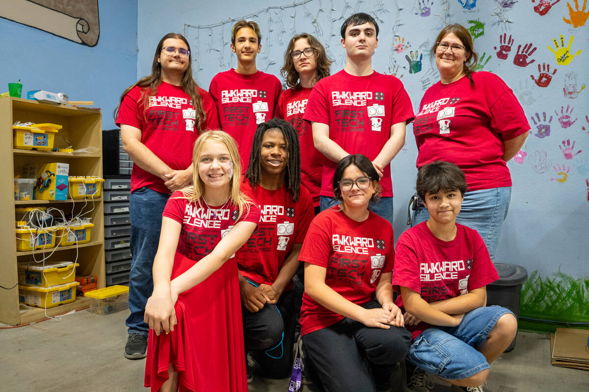 Head coach Jennifer Riendeau and members of the 4-H robotics team Awkward Silence gather follow ...
