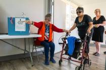 Poll workers at the front entrance of Bob Ruud Community Center guided people to the check-in a ...