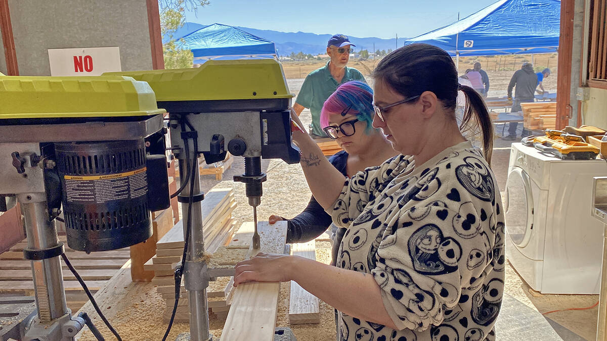 Volunteers work the drill press at the Nye County Sleep in Heavenly Peace Community Bed Build, ...