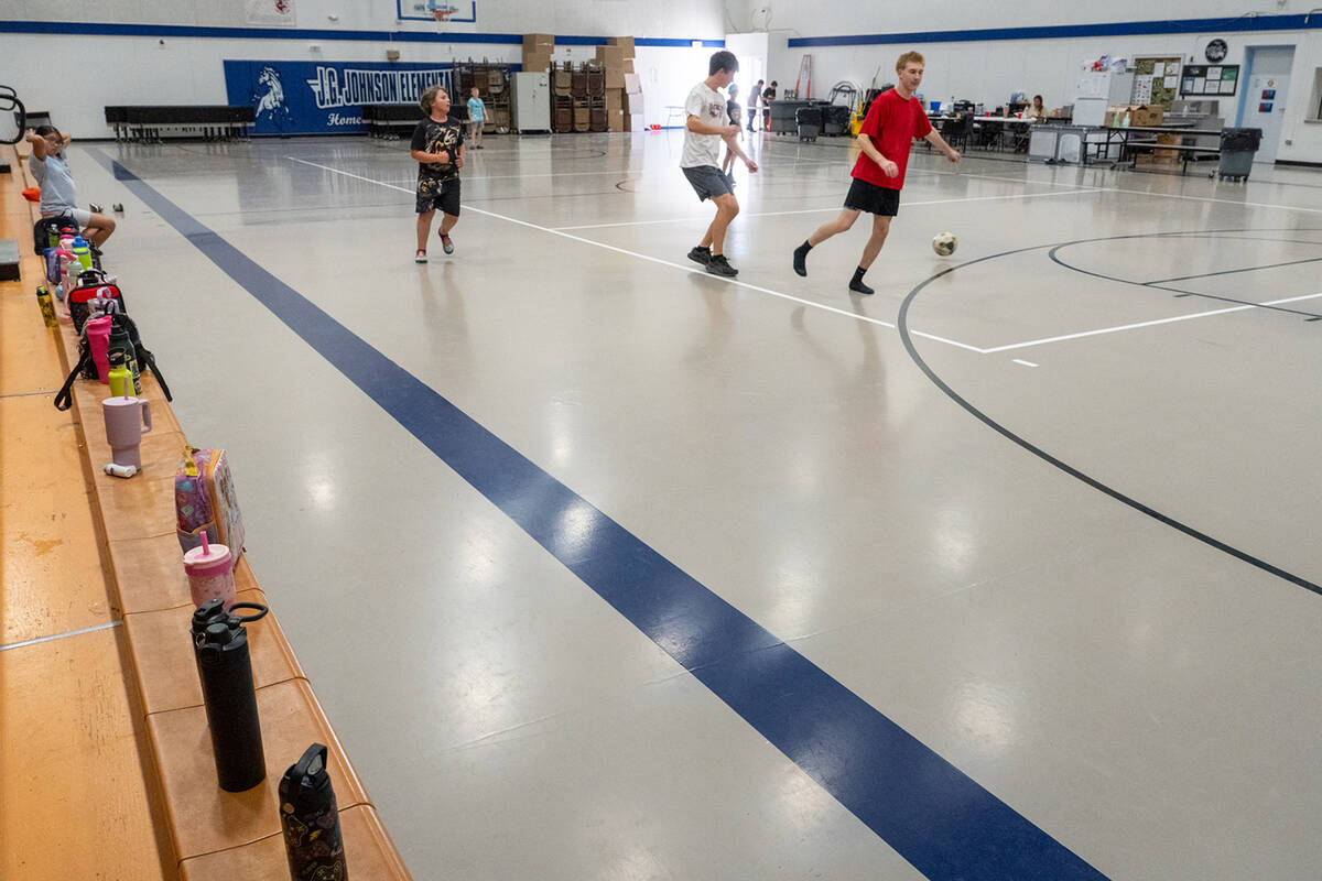 Participants in the Pahrump Valley Youth Activities summer program play soccer inside J.G. John ...