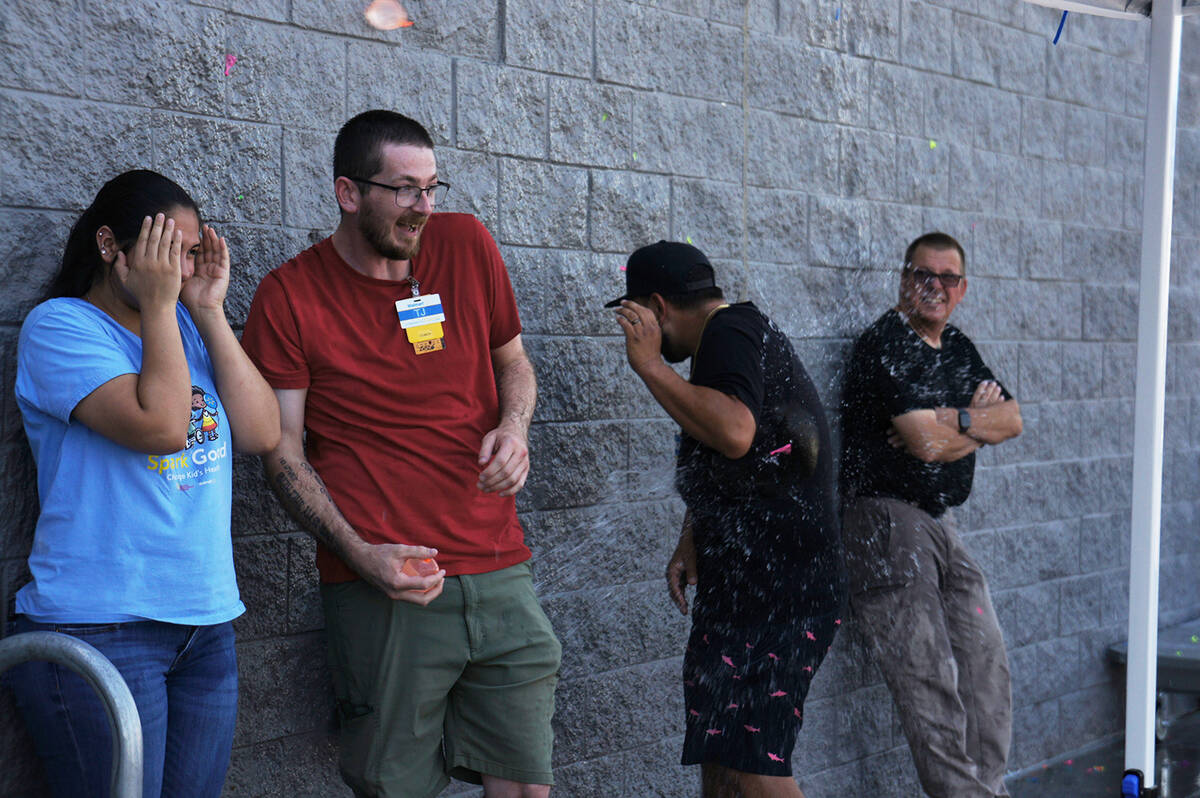 Walmart staff take cover and dodge water balloons thrown at them. (Elijah Dulay/Pahrump Valley ...
