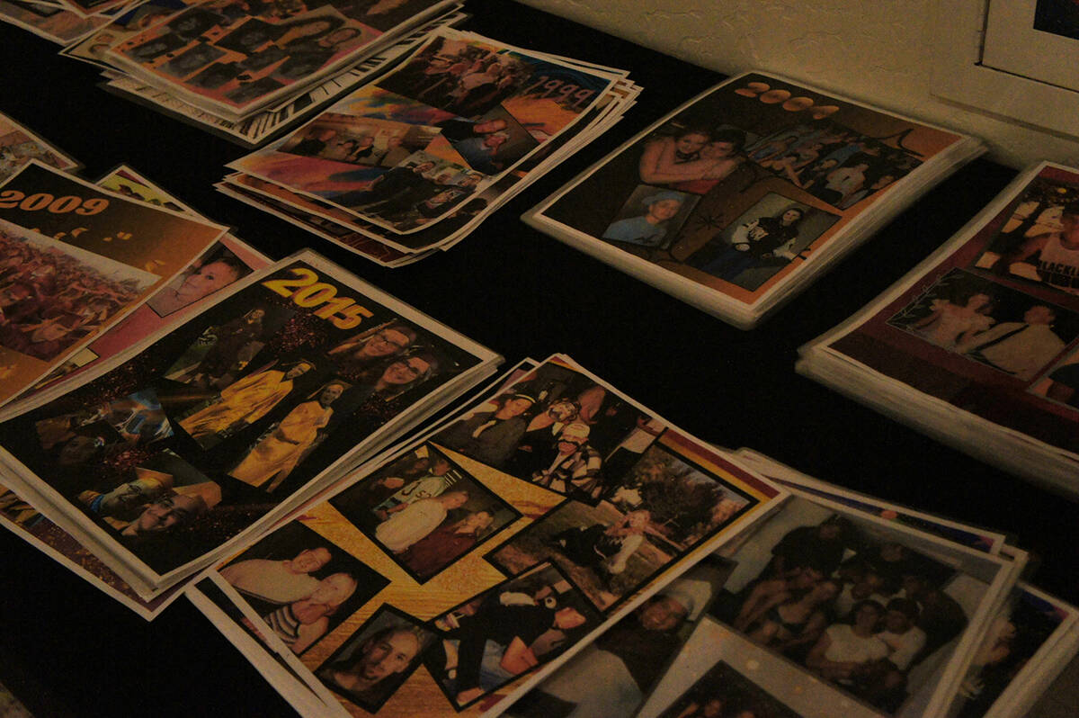 This table at the reunion showcased various classes' old photos of their time at Pahrump Valley ...