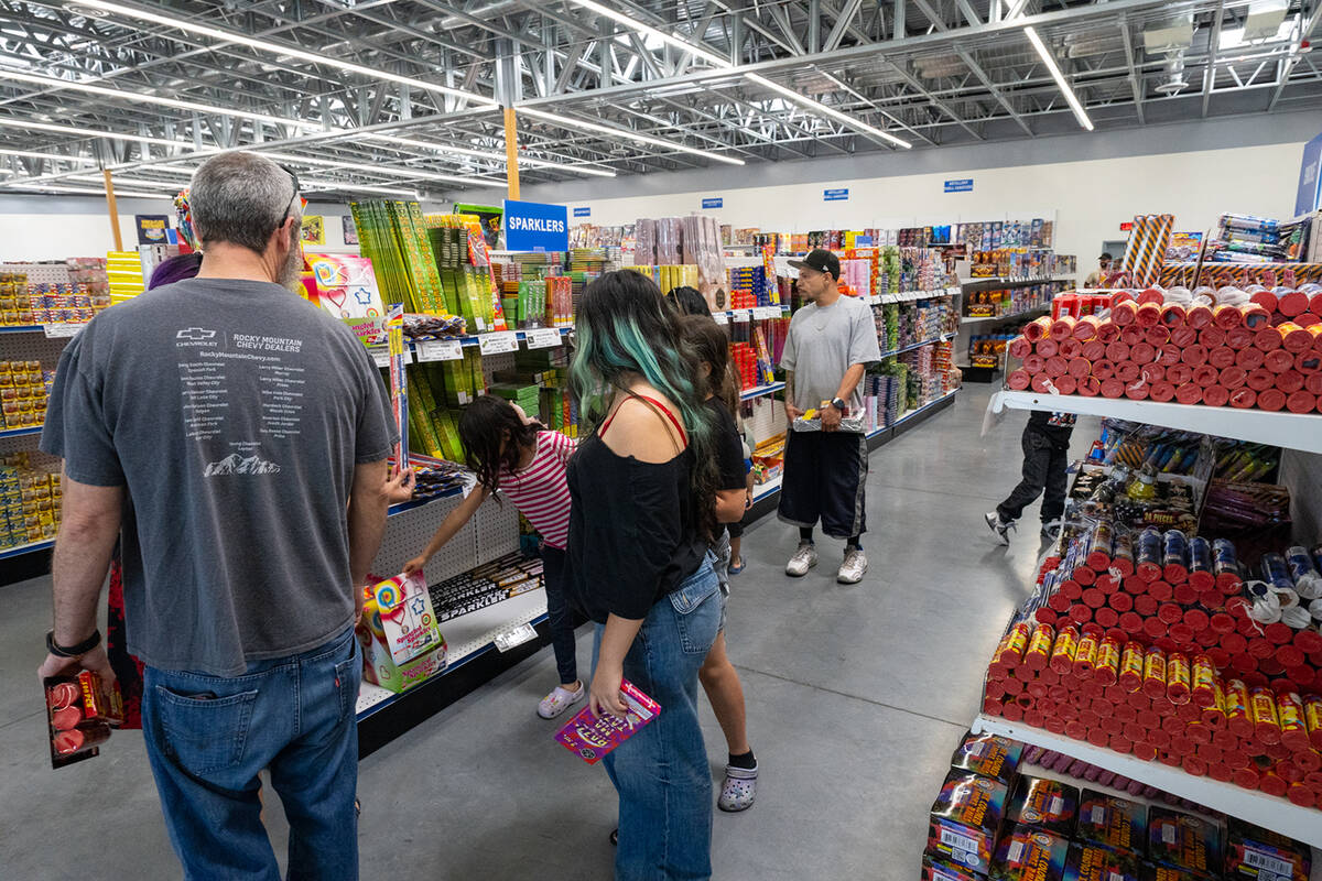 A group of customers at Battle Born Fireworks in Pahrump browse the store's sparkler section. ( ...