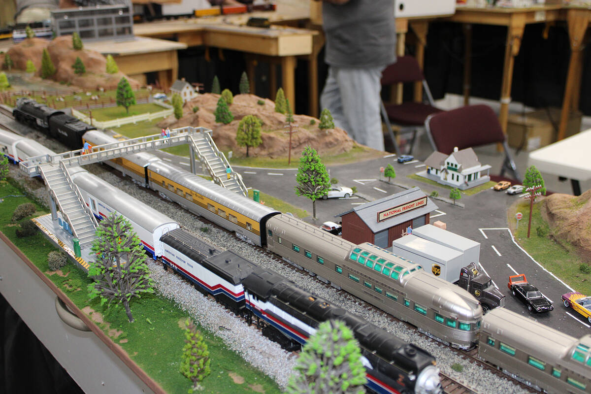 Miniature people, a pedestrian overpass and passing trains all create a story for attendees of ...