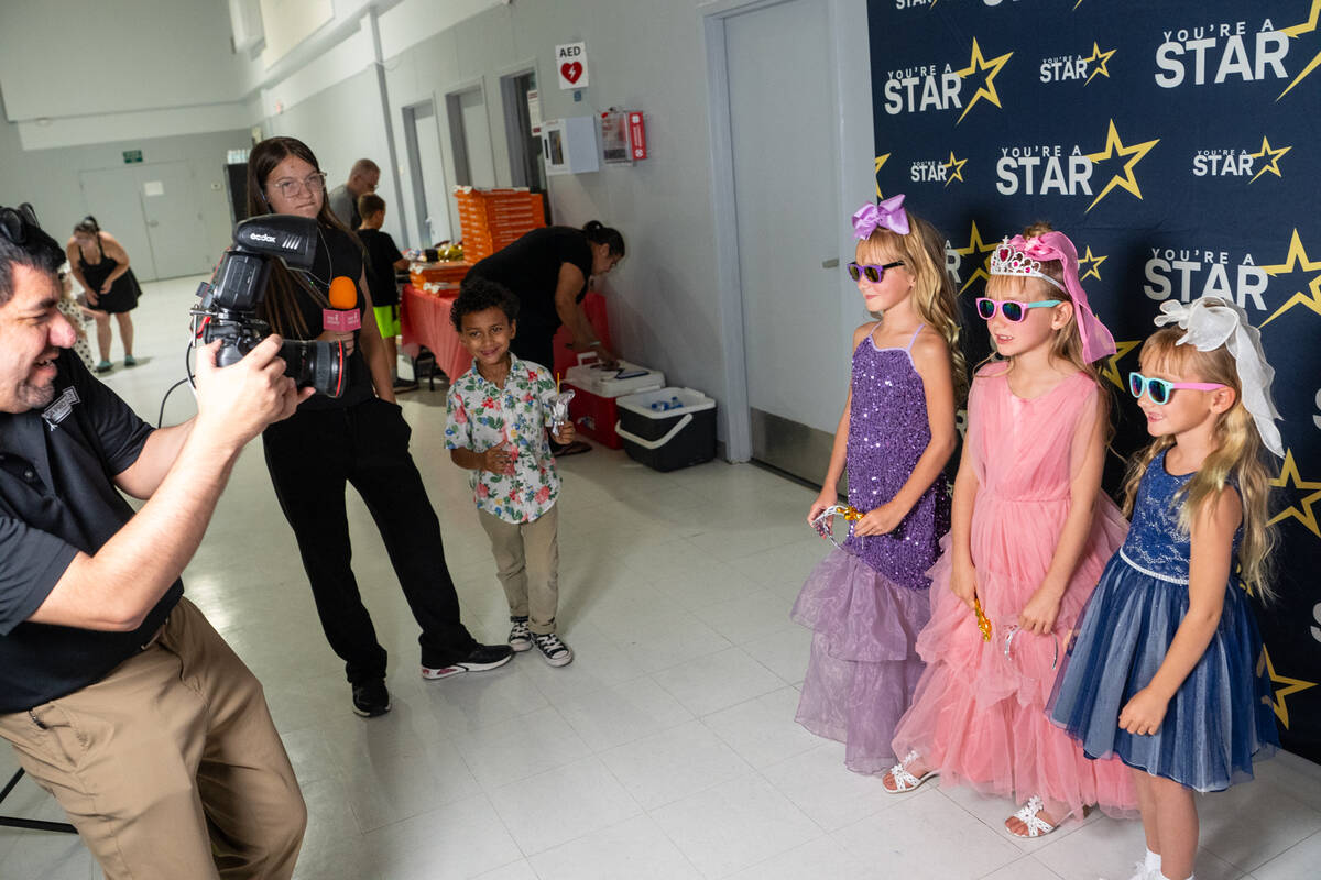 A professional photographer took pictures of youngsters with their free tiaras, sunglasses and ...