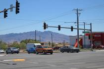 Drivers proceed through the intersection of Highway 160 and Homestead Road, some going straight ...
