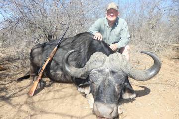 Wayne Bliss poses with his African Cape Buffalo, which is fearless and ferocious when cornered ...