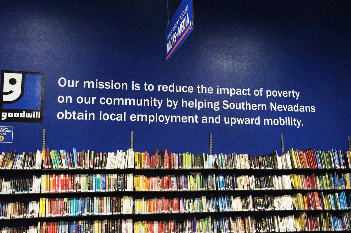 This quote shares Goodwill of Southern Nevada's mission above the books and media wall at the P ...