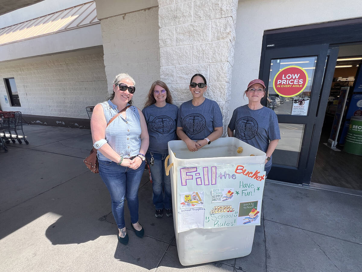 Volunteers pose for a quick photo in front of Smith's, where they braved the valley's high temp ...