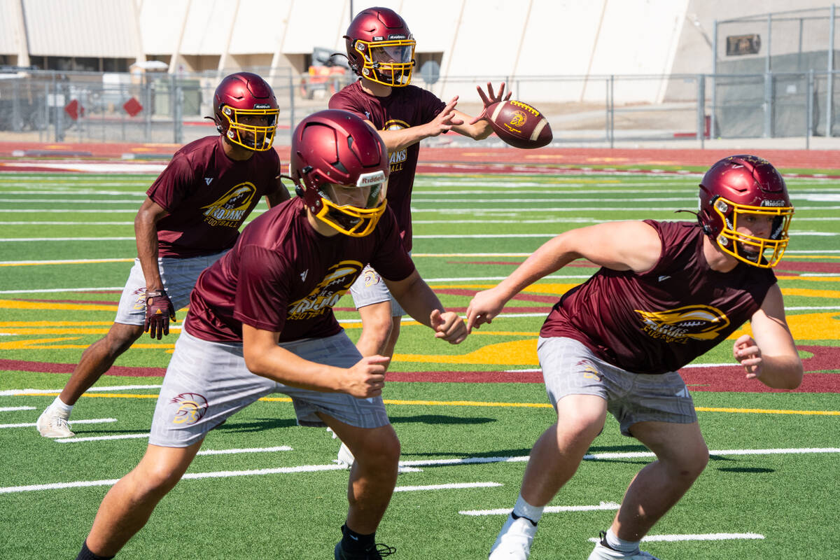 Sophomore Evan Strain, who earned the starting quarterback job after a strong summer, works thr ...