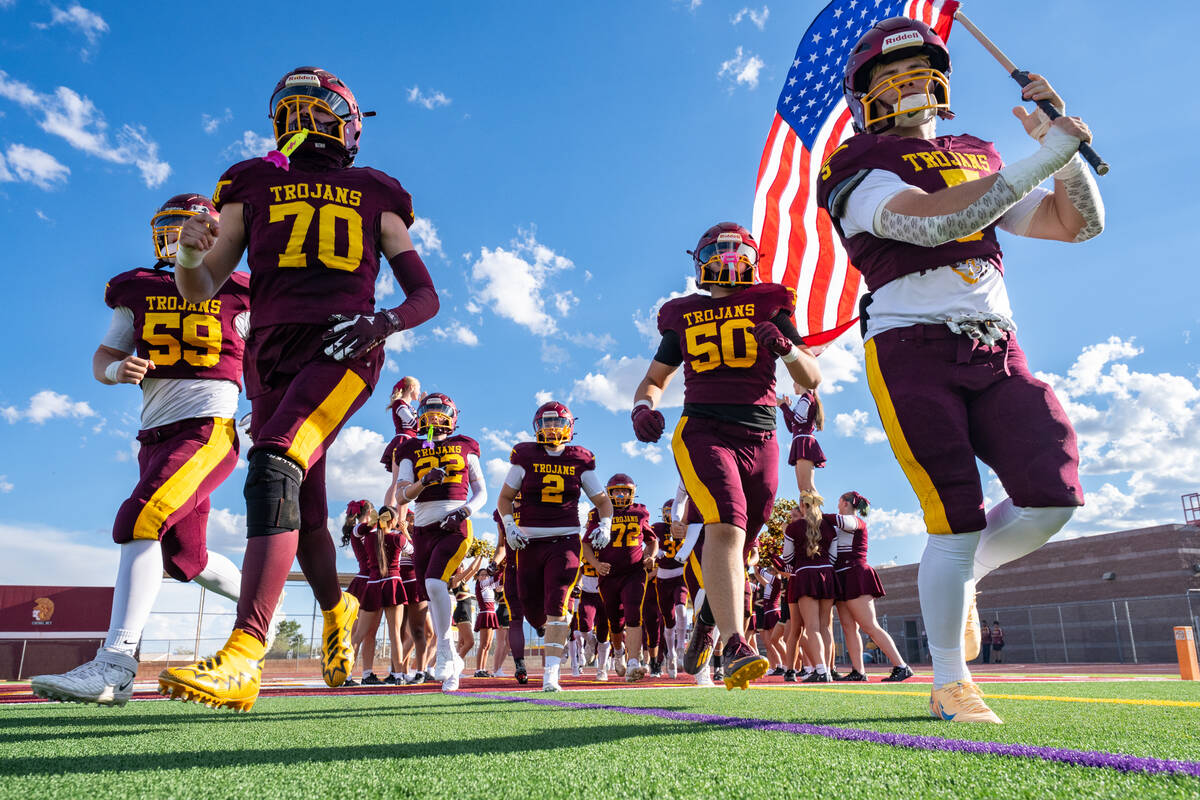 Pahrump Valley players take the field before Friday’s season opener against Providence Hall. ...