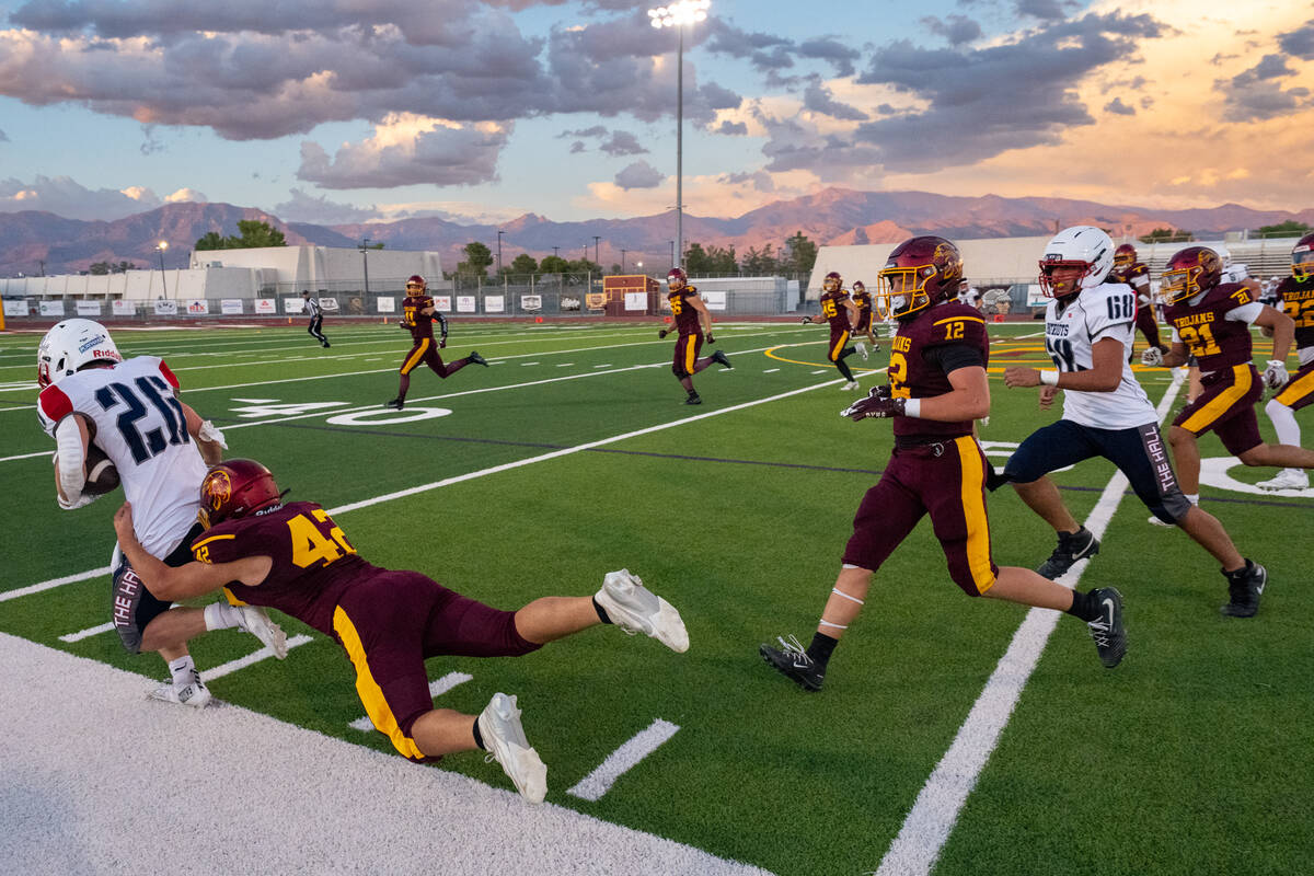 Christien Ramiscal brings down a Providence Hall ball carrier near the sideline during Pahrump ...