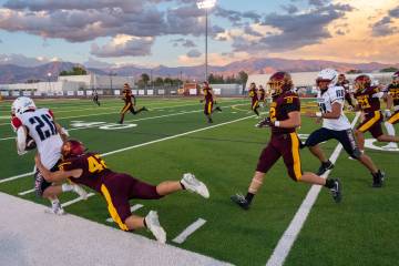 Christien Ramiscal brings down a Providence Hall ball carrier near the sideline during Pahrump ...