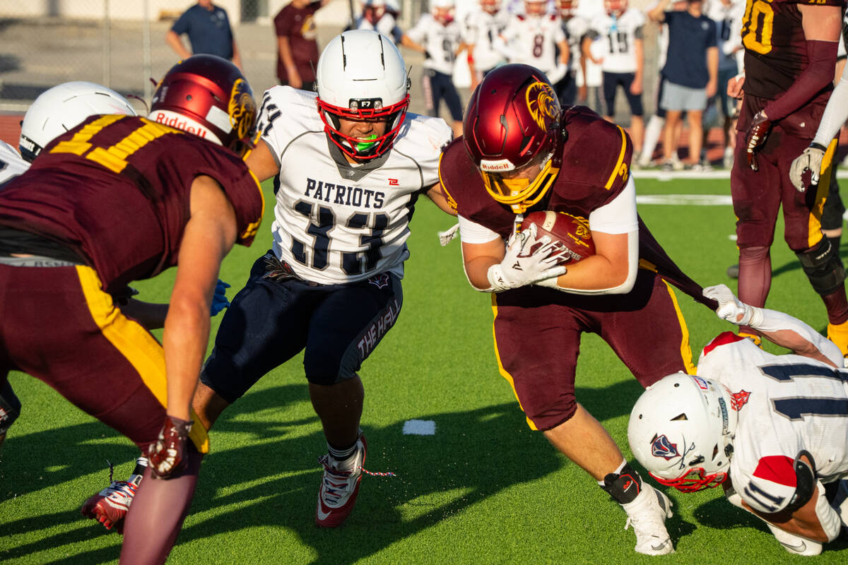 Pahrump Valley’s Preston Dockter fights through the Providence Hall defense during the Trojan ...