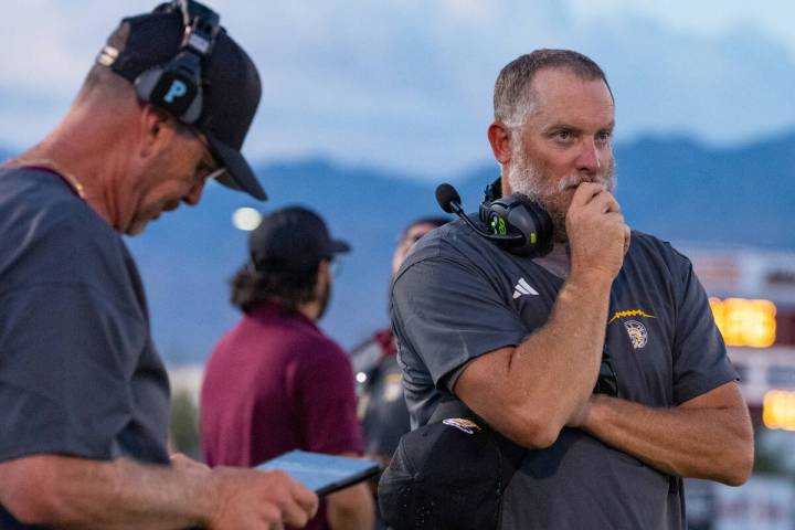 Pahrump Valley head coach Toby Henry watches from the sideline during the Trojans’ 47-7 loss ...