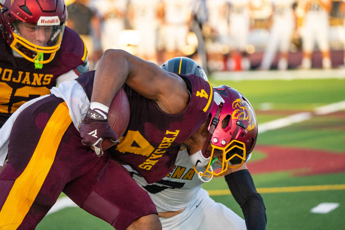 Pahrump Valley senior Iyan Bosket carries the ball through contact during Friday’s game again ...