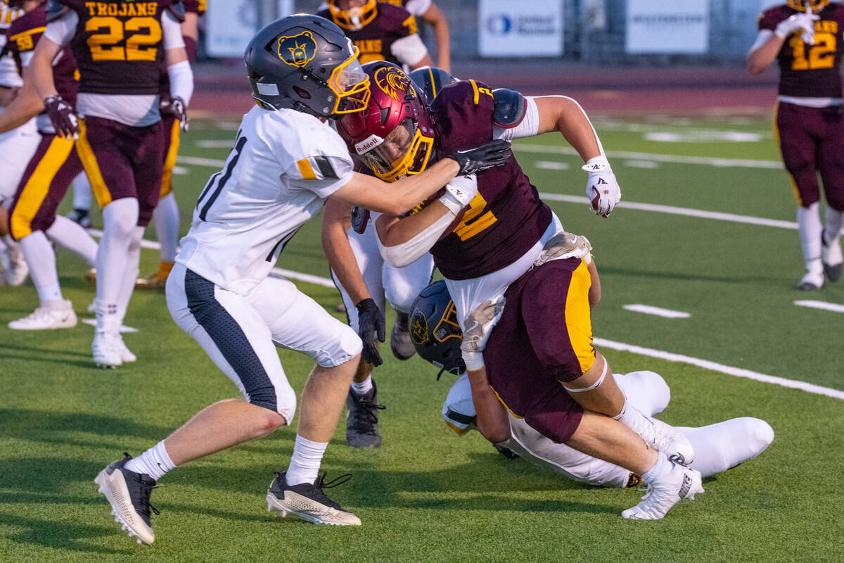 Pahrump Valley senior Preston Dockter is wrapped up by Galena defenders during Friday’s 47-7 ...