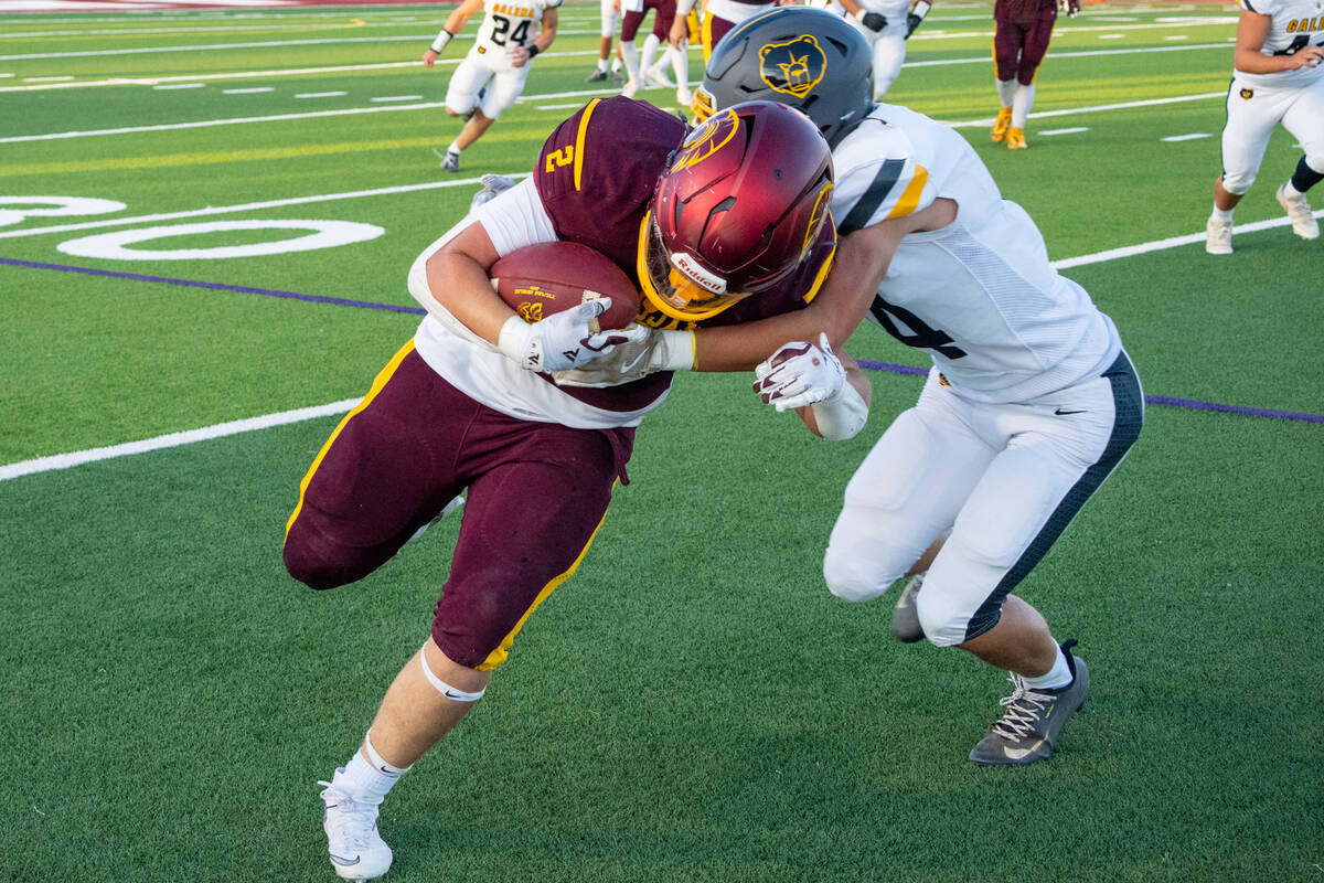 Pahrump Valley senior Preston Dockter protects the ball as a Galena defender closes in during F ...