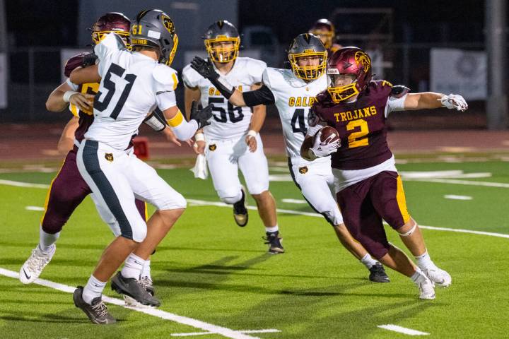 Pahrump Valley senior running back Preston Dockter carries the ball through the Galena defense ...