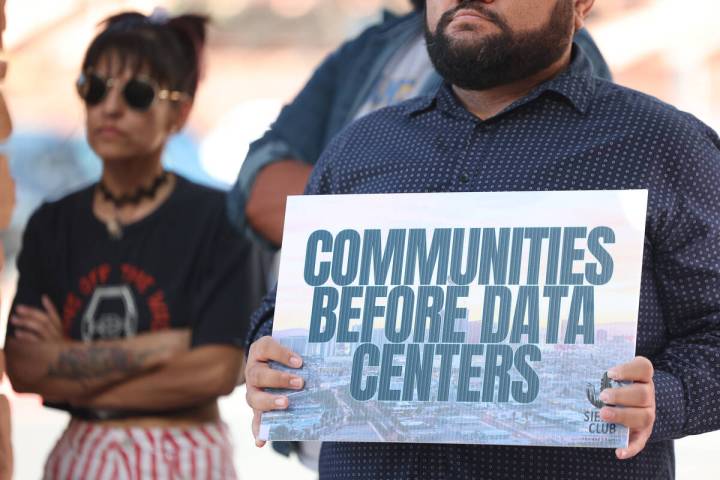 Protesters hold signs during a Sierra Club press conference calling for a data center moratoriu ...