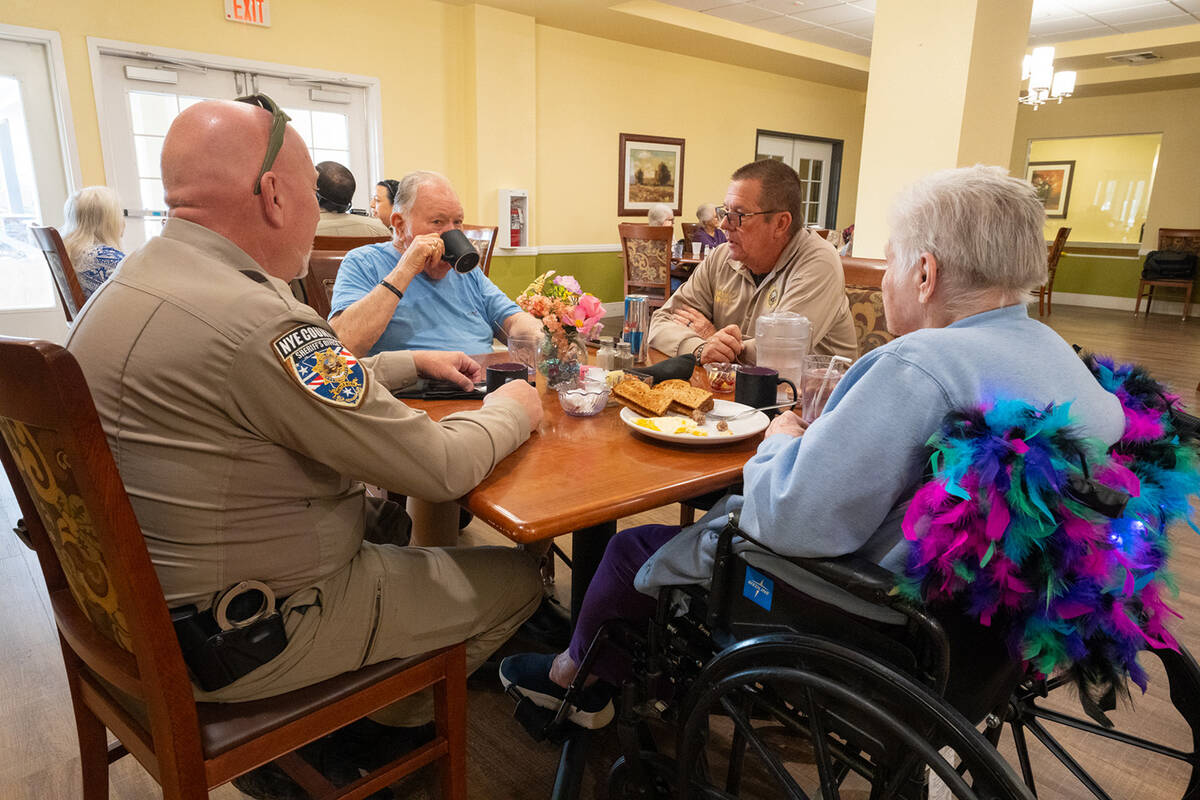 Lt. William Gray (left) and Nye County Sheriff Joe McGill (right) talk with residents over brea ...
