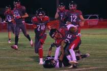 Tonopah defenders swarm a Round Mountain ballcarrier as seniors Levi Harhay (12) and Tristan Fi ...