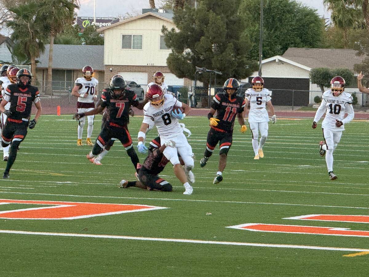 Pahrump Valley’s Tristan Schumacher (8) carries the ball as Chaparral defenders try to bring ...