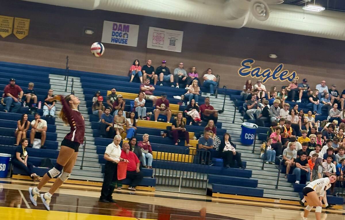 Pahrump Valley senior Riley Saldana sends a serve toward Boulder City during the Trojans’ str ...