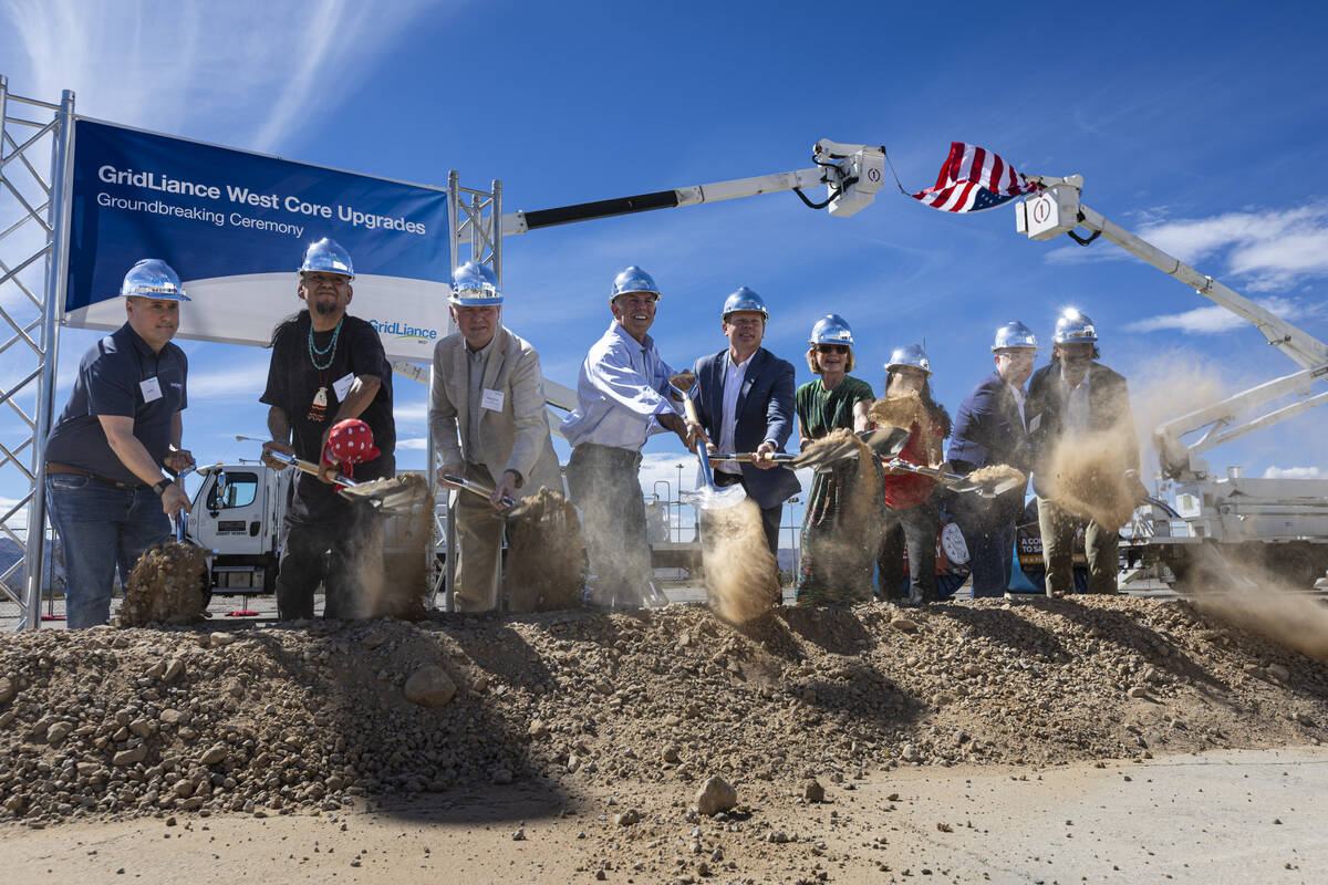Officials shovel dirt during a groundbreaking ceremony for GridLiance West, which will see new ...