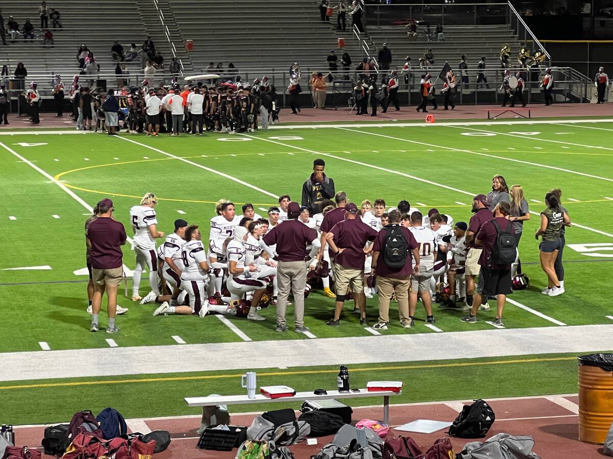 Pahrump Valley players gather around their coaches during the Sept. 4 game at Chaparral. The Tr ...
