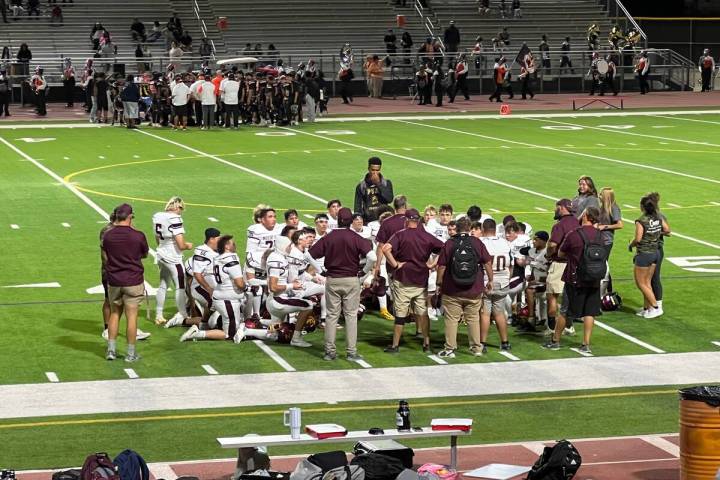 Pahrump Valley players gather around their coaches during the Sept. 4 game at Chaparral. The Tr ...