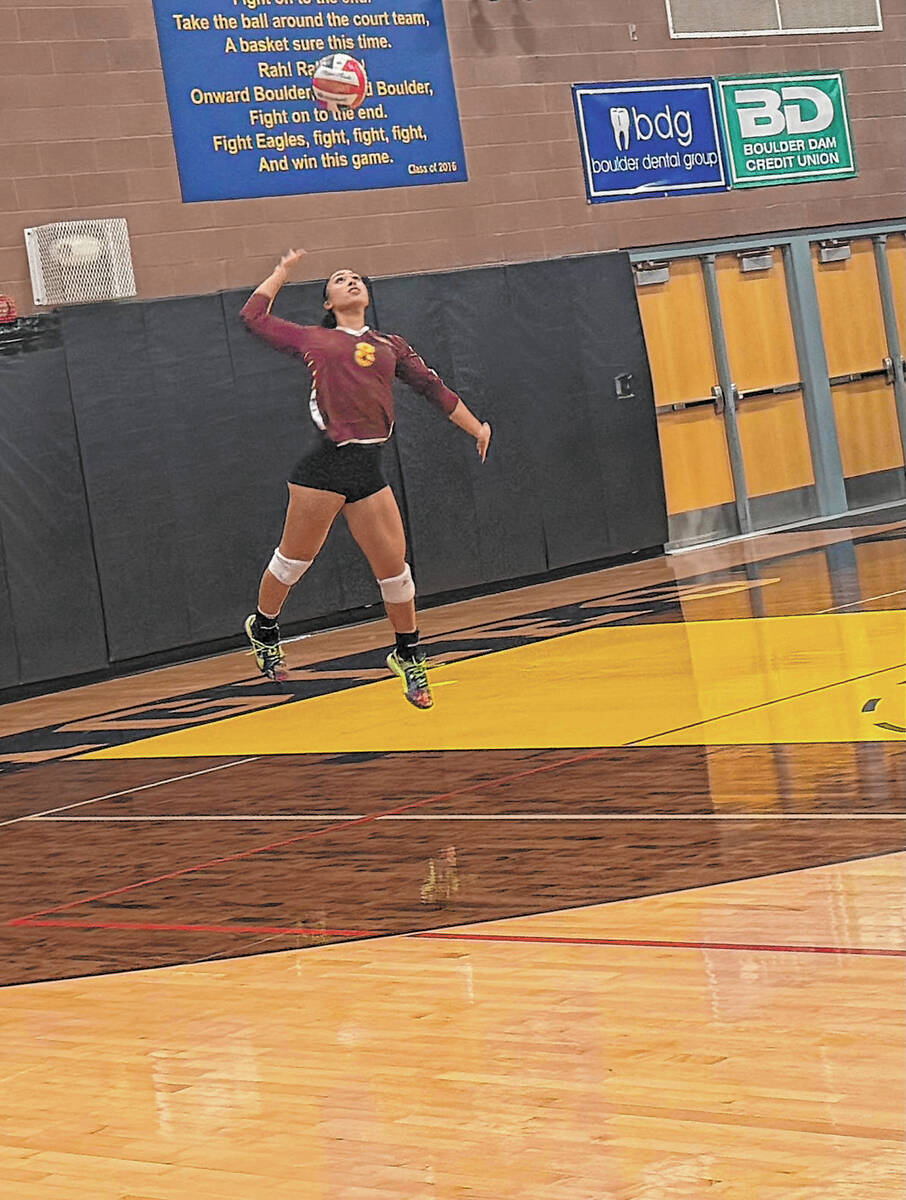 Pahrump Valley’s Xe’ane Kamanu prepares to serve during the Trojans’ three-set victory at ...