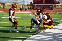 Pahrump Valley’s Paul Walker (22) and Kobe Farmer (21) tackle a Providence Hall ball carrier ...