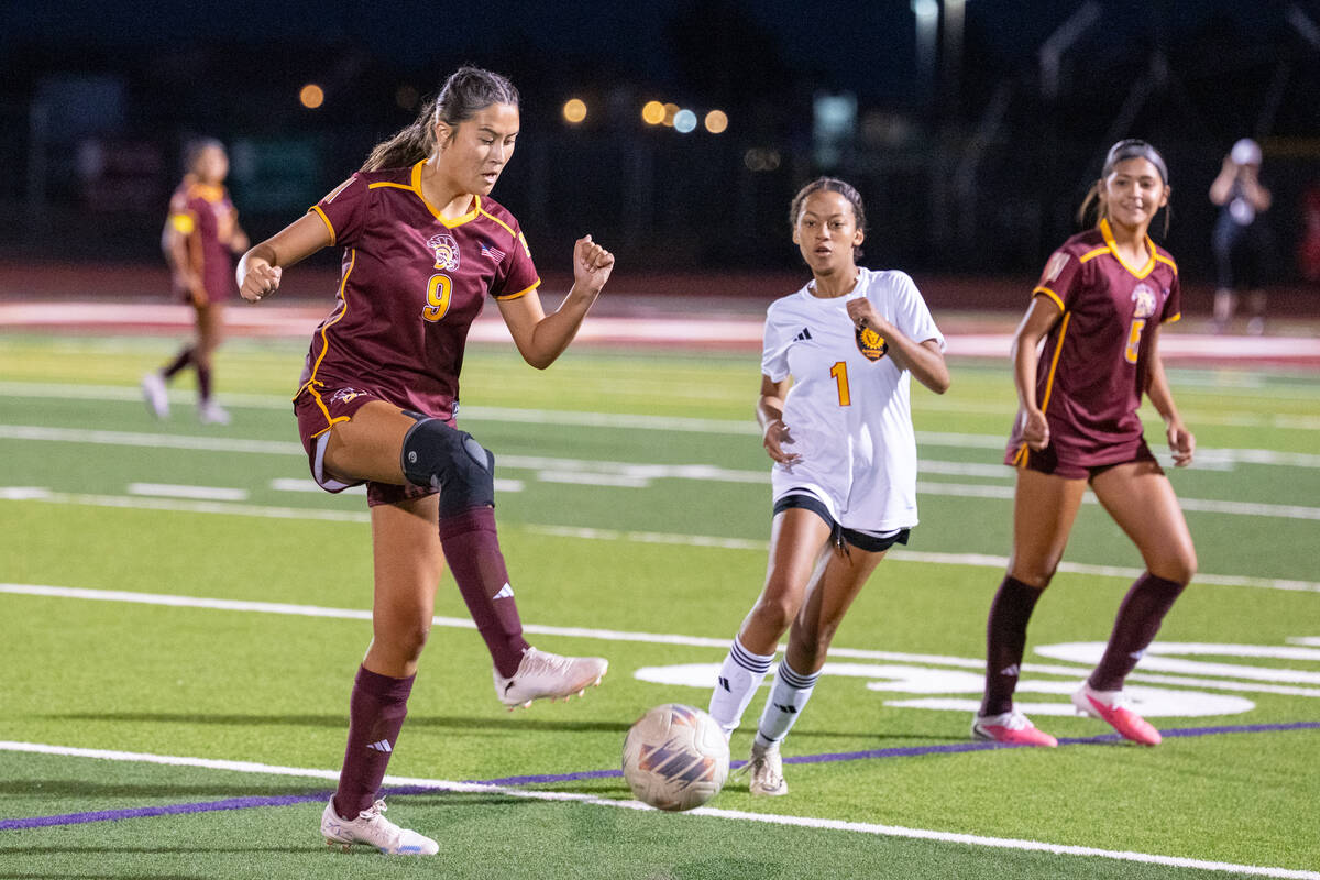 Pahrump Valley’s Mary Miller (9) plays the ball as a Somerset Academy Losee opponent closes i ...
