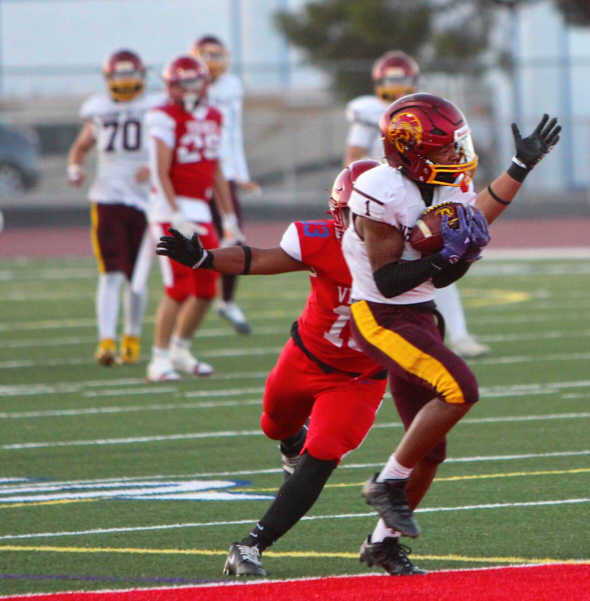 Pahrump Valley’s Angel Ware secures the football with a Valley defender close behind during t ...