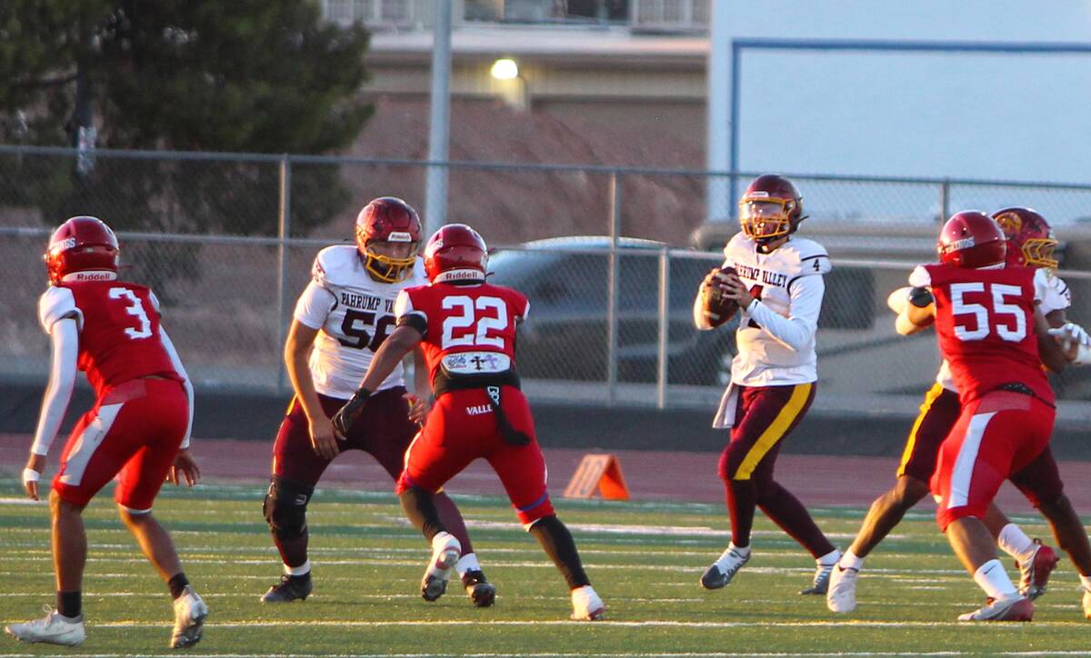Pahrump Valley sophomore quarterback Wyatt Cross looks downfield behind his blockers during the ...